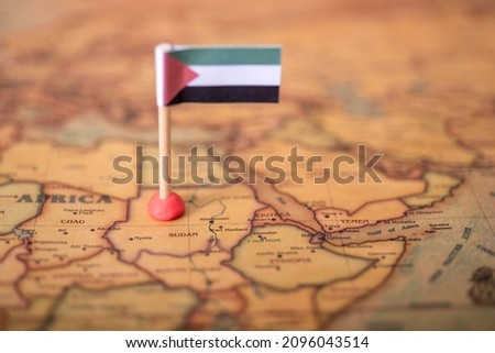 The flag of Sudan on the world map. The concept of travel and tourism. Royalty-Free Stock Photo #2096043514
