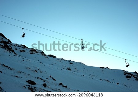Ski resort, cable car (aerial lift) among snow-covered mountain peaks (over 3000 meters).