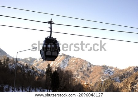 Ski resort, cable car (aerial lift) among snow-covered mountain peaks (over 3000 meters).