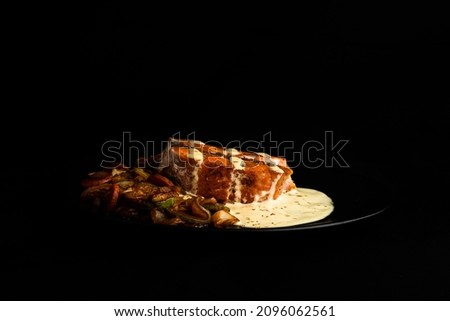 Seared Salmon With Grilled Vegetables And Lemon Aioli On Black Plate With Black Background