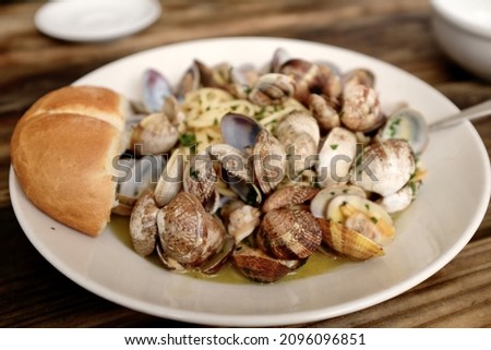 A closeup of delicious steamed clams on a plate Royalty-Free Stock Photo #2096096851