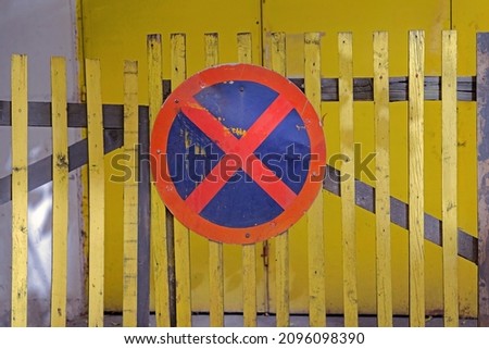 No parking traffic sign attached to retro wooden house fence