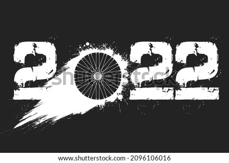 Numbers 2022 and flying abstract bike wheel made from blots with by milky way in grunge style. Happy New Year 2022. Design template for greeting card. Vector illustration on isolated background