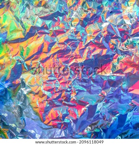 Mixed colors on aluminium foil background. Minimal abstract flat lay concept. Creative modern texture.