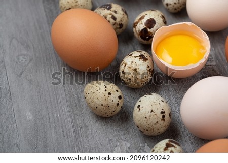 Top view of chicken and quail eggs on table