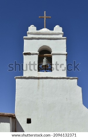 A vertical shot of the Church of San Pedro de Atacama bell cote in the blue sky background, Chile Royalty-Free Stock Photo #2096132371
