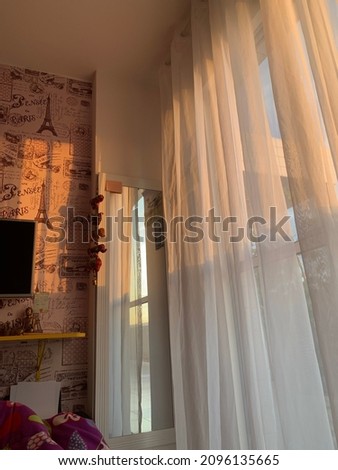 Teenager's pink bedroom lit by sunlight