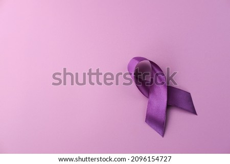 Purple ribbon as symbol of Cancer Awareness Month (World Cancer Day) over purple color background, copy space.
 Royalty-Free Stock Photo #2096154727