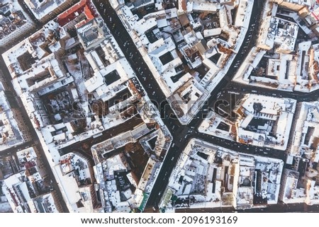 Old town in winter, during sunrise without people. The historical center of the city of Lviv. Roofs covered with snow. Drone photo