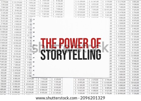 THE POWER OF STORYTELLING text on paper with calculator,magnifier ,pen on the graph backgroundd