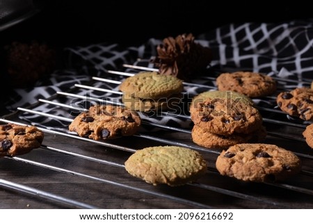 Chocolate cookies, on a cooling tray, photo of dark shades - dark mood