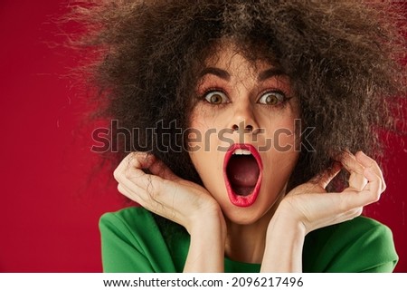 Pretty young female Afro hairstyle green dress emotions close-up color background unaltered