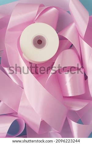 Pink ribbon for gift wrapping. Gentle romantic background, texture.