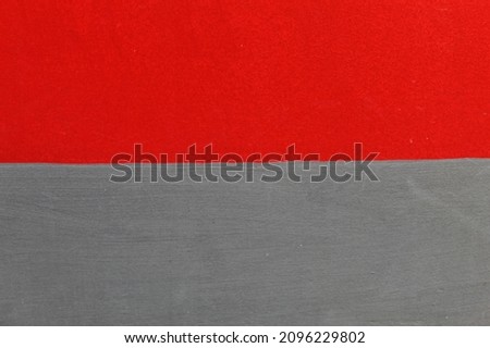 The wall surface of the building is painted red and gray.