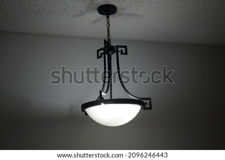 Hanging black pendant light in a house