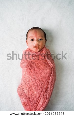 Newborn little baby girl with angels kiss birthmark on the forehead Royalty-Free Stock Photo #2096259943