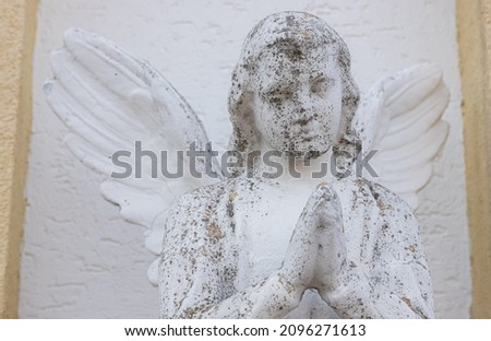 Vintage image of a sad angel on a bright background. detail.