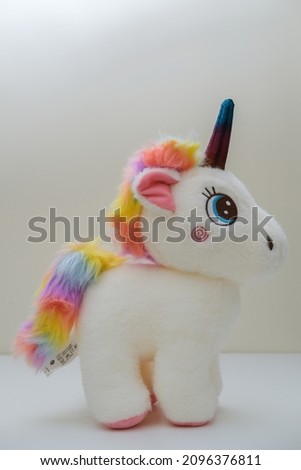 This is a photo of a white unicorn toy with horns