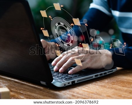 In the office, an IT expert is setting up a Document Management System (DMS) on a laptop computer. Corporate file archiving software Royalty-Free Stock Photo #2096378692