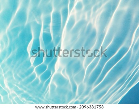 Closeup blur​ abstract​ of​ surface​ blue​ water​ in​ the​ deep​ sea​ for​ background. The​ pattern​ of​ blue​ water​ for​ background. Abstract​ of​ surface​ blue​ water for​ background.