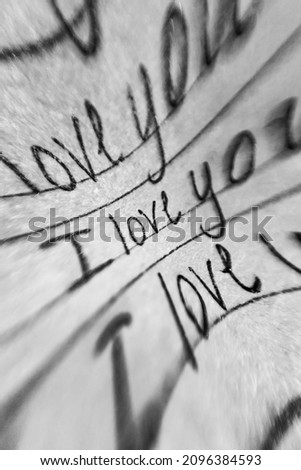 Abstract vertical monochrome image. Paper with the inscription "I love you".
