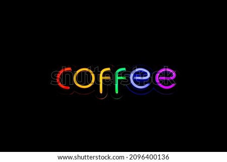 Word COFFEE: glowing rainbow neon sign lettering at a cafe isolated on black background