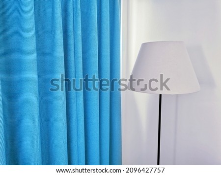 white room interior design With blue curtains and white floor lamps of hotel accommodation, resort or bedroom, living room in the house.