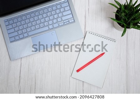 Blogger or freelancer workspace with red notebook, card, pen and keyboard on white background. Concept business antd communication. High quality photo