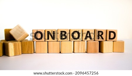 Onboard and onboarding symbol. The concept word Onboard on wooden cubes. Beautiful white table, white background, copy space. Business onboard and onboarding concept.