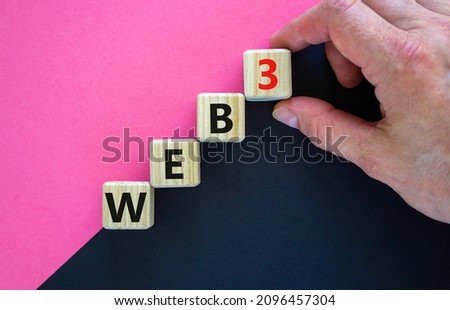 WEB3 or web 3 symbol. Wooden cubes with concept words WEB 3. Beautiful purple and black background, copy space. Businessman hand. Business, technology web3 and WEB 3 or 3.0 concept.