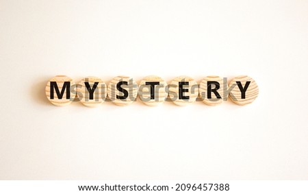 Mystery symbol. The concept word Mystery on wooden circles. Beautiful white background, copy space. Business and mystery mysterious concept.