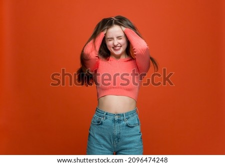 Happy young girl burying hands to long shiny strong hair, enjoying result of beauty haircare products use Royalty-Free Stock Photo #2096474248