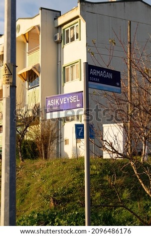 street and street sign standing in front of building