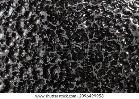 Detailed metal coating texture. Corrosion-resistant coating. Abstract background. A closeup. Dark colors. Background image. Space for text. Desktop wallpaper. Top view.