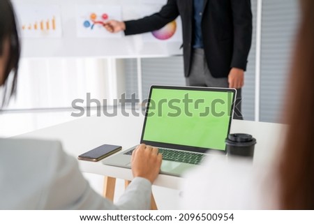 Businesswoman in business meeting using computer proficiently at office room . Corporate business team collaboration concept .