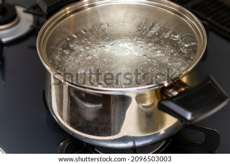 Metal pot with boiling water