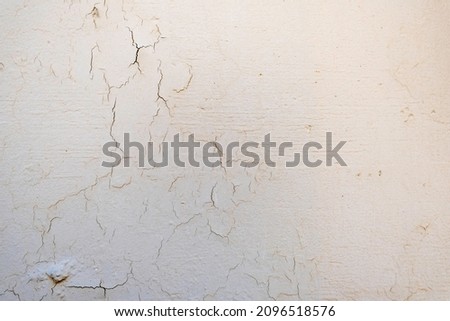 Old concrete wall with white shabby paint.