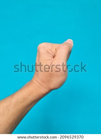Human hand brown blue background