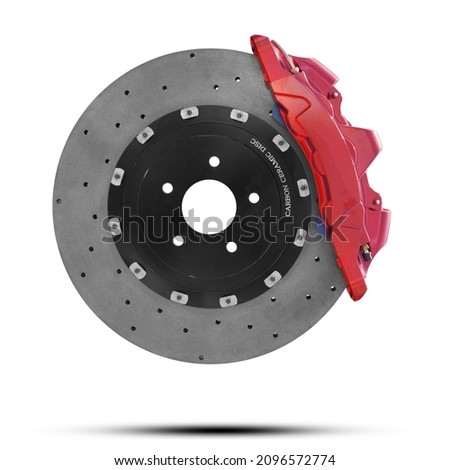 Carbon ceramic disc Brake and Red Calliper from a Racing Car Disc brake isolated on white background. This has clipping path.