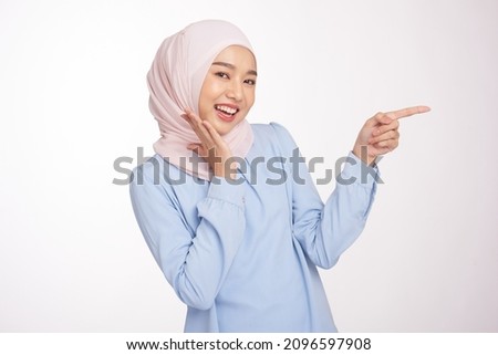 Beautiful hijab young girl with hands pointing empty space presenting with smiling and confidently, isolated on white background. Royalty-Free Stock Photo #2096597908