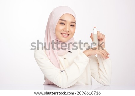 Beautiful muslim woman girl wearing Hijab showing serum bottle of hemp, cbd serum Royalty-Free Stock Photo #2096618716