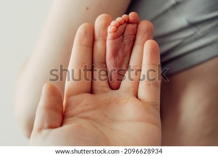 Baby feet in father hands. Tiny Newborn Baby's feet close up. Happy Family concept.