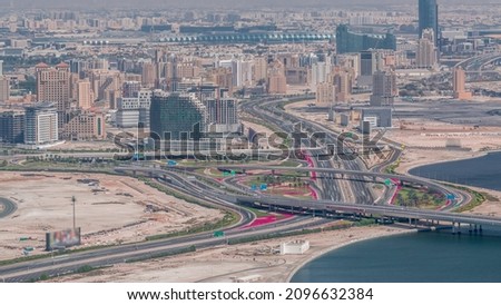 Skyline of the Dubai city with modern skyscrapers in Deira and Zabeel district and big highway intersection aerial timelapse from Business Bay, United Arab Emirates