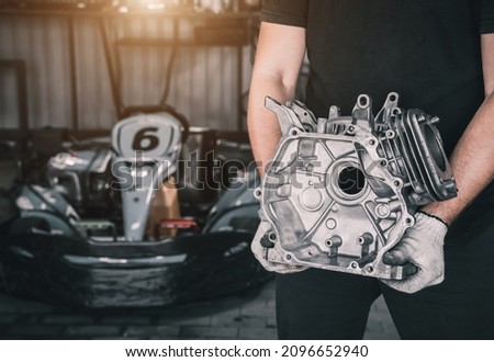 The mechanic go kart racing service pours fuel into the tank Royalty-Free Stock Photo #2096652940