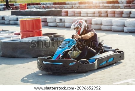 A young man drives a go kart at circuit Royalty-Free Stock Photo #2096652952
