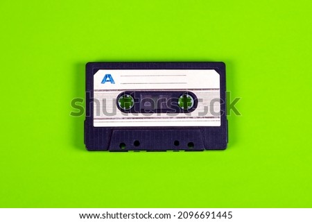 Old Audio Cassettes on the Green Paper Background closeup