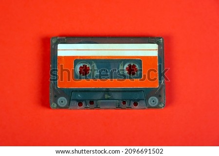 Old Audio Cassettes on the Red Paper Background closeup