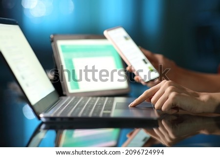 Close up portrait of a woman hand using multiple devices in the night at home Royalty-Free Stock Photo #2096724994