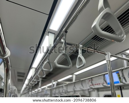 Hanging straps in Subway , empty background of metro train 