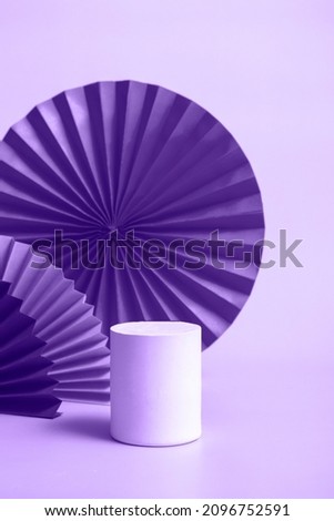 White podium with red paper fan background for branding and product presentation. Vertical format. toning in very peri monochrome color